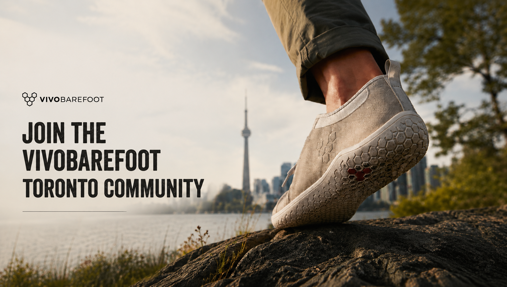 Person wearing a Vivobarefoot shoe with Toronto skyline in the background